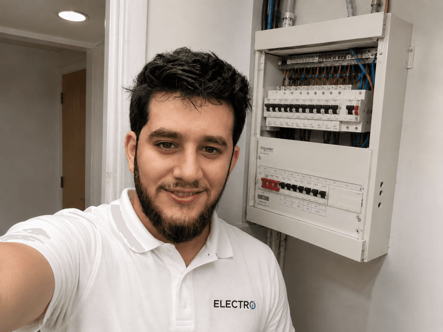 Ismael, the electrician behind Electro, in front of a consumer unit he worked on